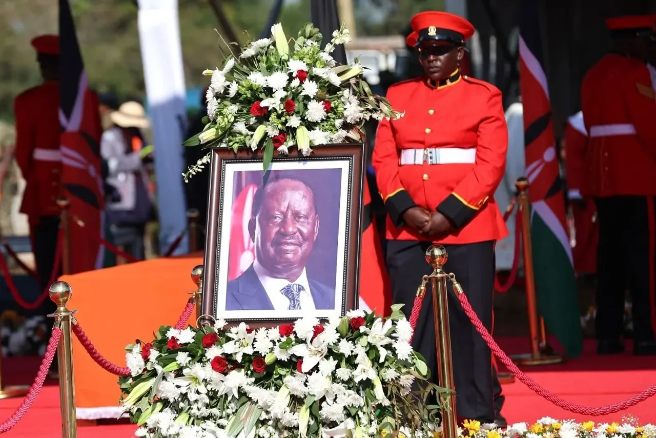 A soldier stands behind the portrait of the late Raila Odinga during his funeral service in October 2025 in Bondo, Siaya County