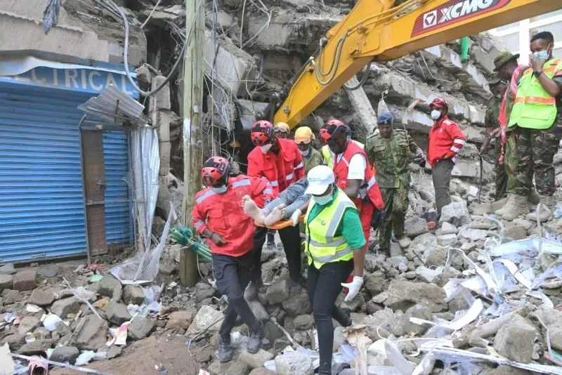 Kenya Red Cross rescuers carry a man who was trapped in the 18-storey building that collapsed in Eastleigh, Nairobi, on October 24, 2026